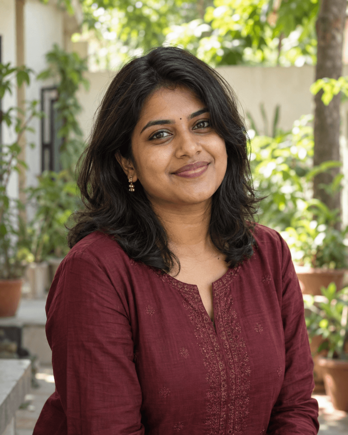 Illustrative portrait of an Indian woman in a burgundy kurta